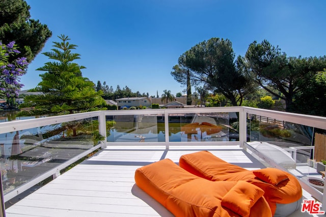 wooden terrace with a water view