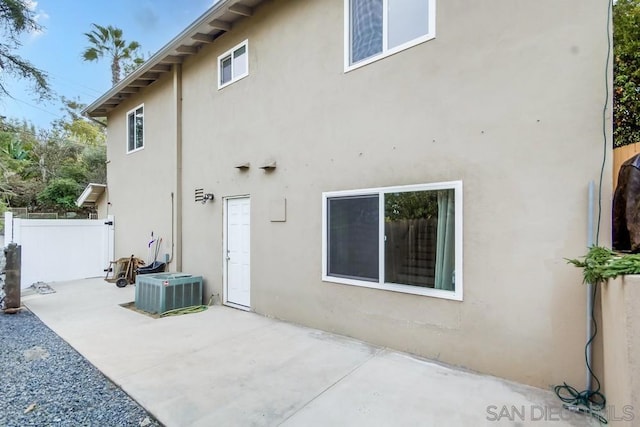 back of property featuring central AC and a patio area