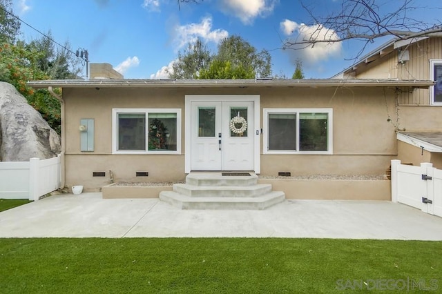 exterior space featuring a front yard and a patio