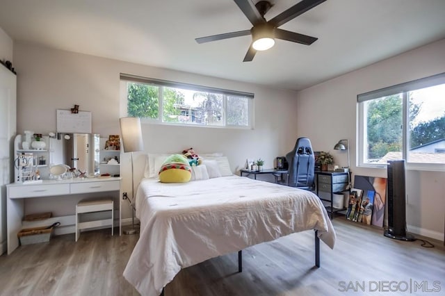 bedroom with ceiling fan and light hardwood / wood-style floors