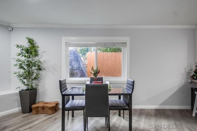 dining area featuring hardwood / wood-style floors and ornamental molding