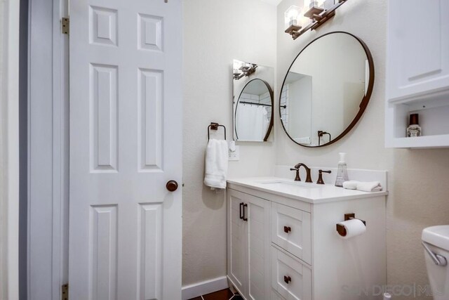 bathroom featuring toilet and vanity