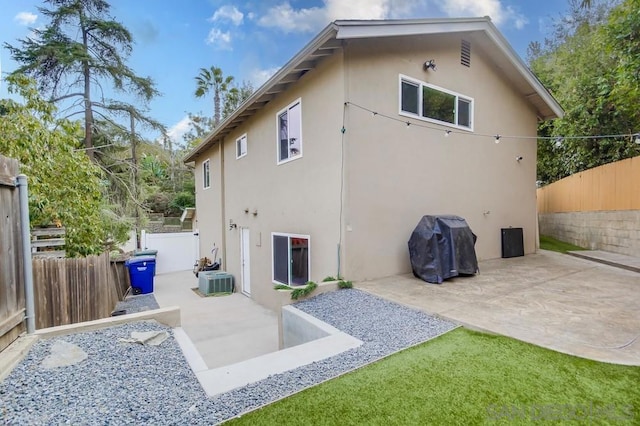 back of house featuring central air condition unit and a patio