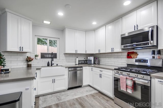 kitchen with sink, white cabinetry, and appliances with stainless steel finishes