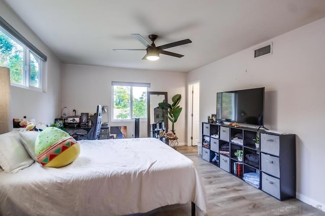 bedroom with ceiling fan and light hardwood / wood-style flooring