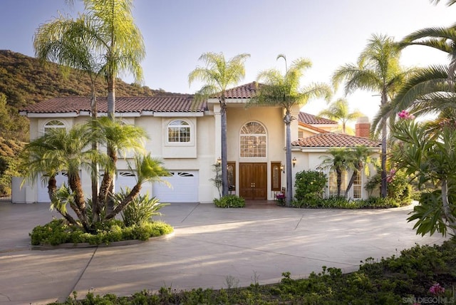 mediterranean / spanish house with a garage