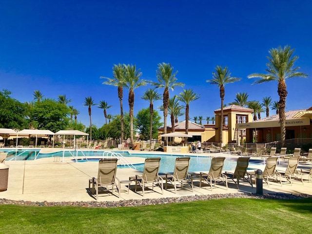 view of swimming pool featuring a yard and a patio