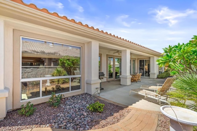 view of patio featuring ceiling fan