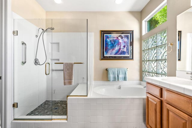 bathroom featuring vanity and separate shower and tub