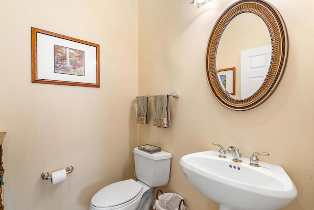 bathroom featuring toilet and sink