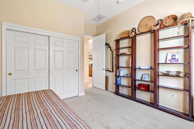 unfurnished bedroom featuring light carpet and a closet