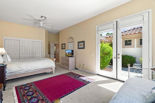 bedroom featuring ceiling fan, a closet, access to exterior, light colored carpet, and french doors