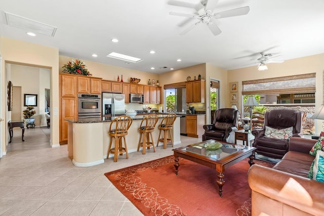 tiled living room with ceiling fan