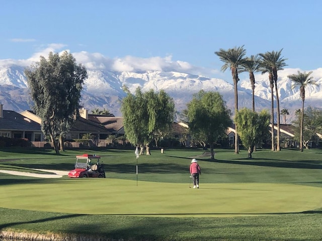 view of community featuring a mountain view and a lawn