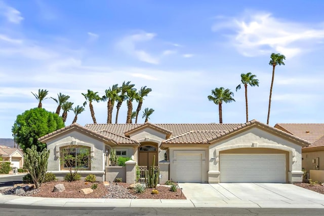 mediterranean / spanish home featuring a garage