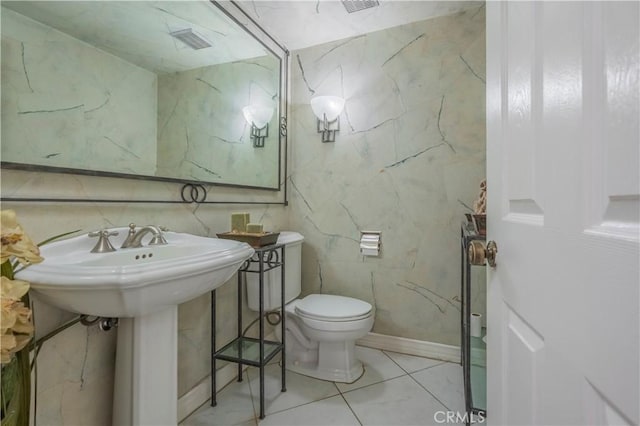 bathroom featuring toilet and tile patterned floors