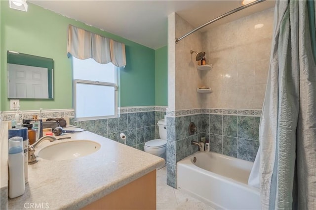 full bathroom with tile patterned flooring, vanity, shower / bath combination with curtain, tile walls, and toilet