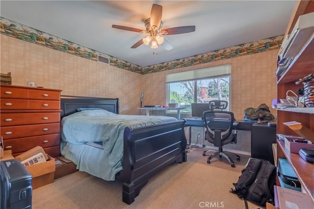 bedroom with ceiling fan and light carpet