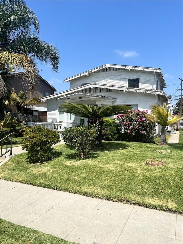 view of side of property featuring a yard