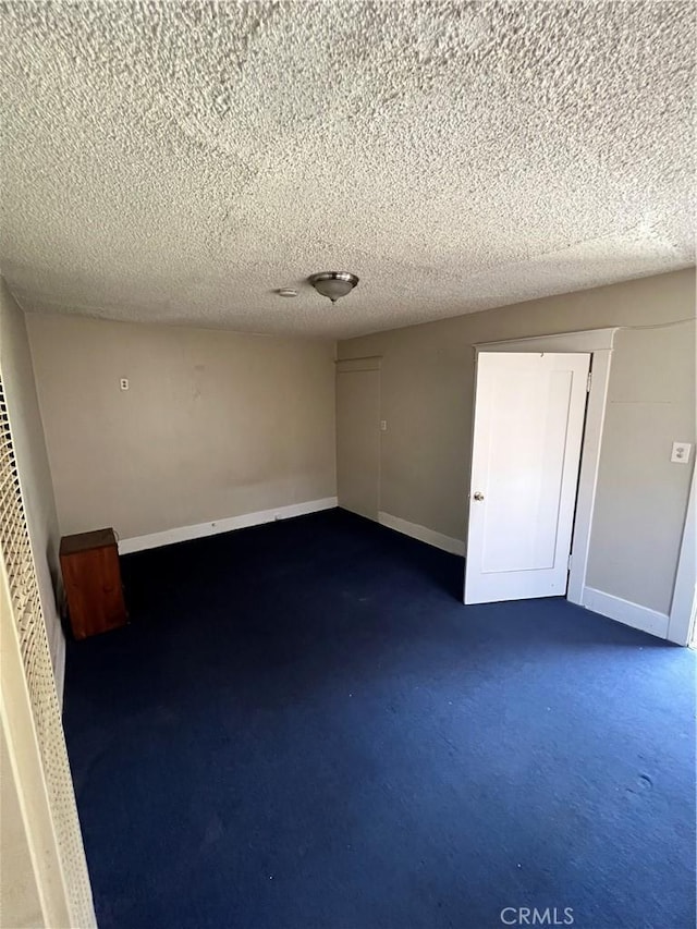 unfurnished room featuring a textured ceiling