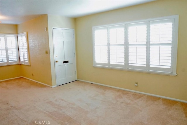 empty room featuring light carpet