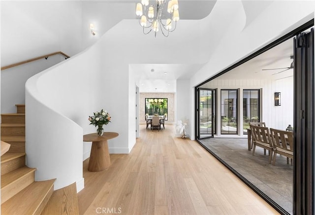 interior space with light hardwood / wood-style floors and a notable chandelier