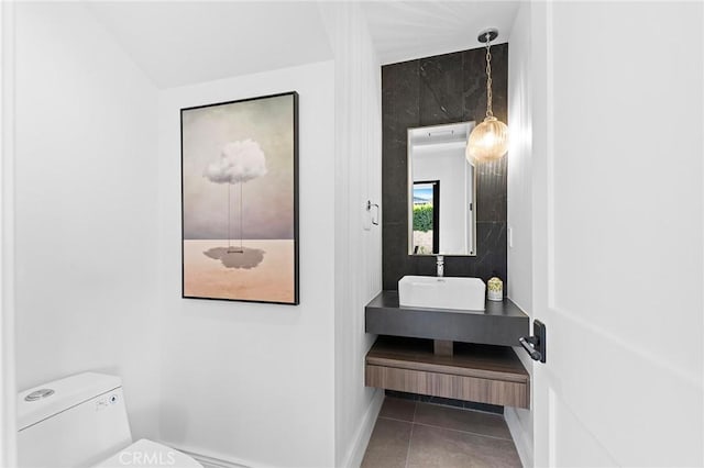 bathroom featuring toilet, tile patterned flooring, and vanity