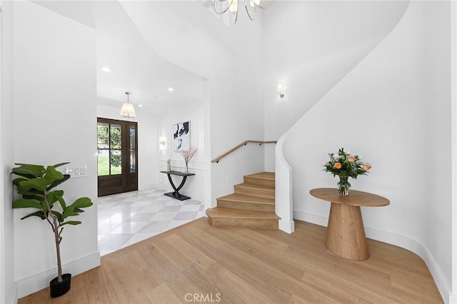 entrance foyer with light hardwood / wood-style flooring and french doors