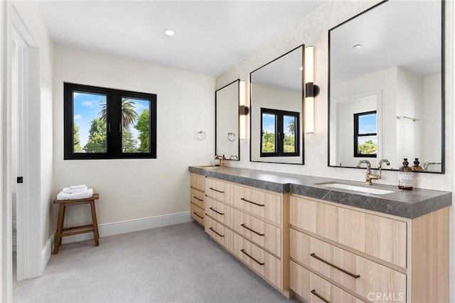 bathroom with concrete flooring, french doors, and vanity