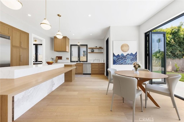 dining room featuring light hardwood / wood-style flooring and sink