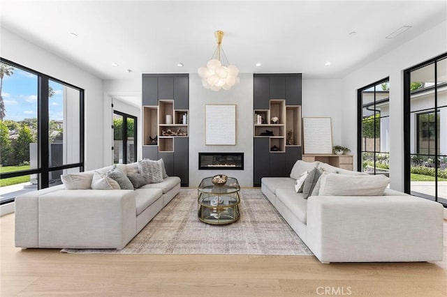 living room with light wood-type flooring and a large fireplace