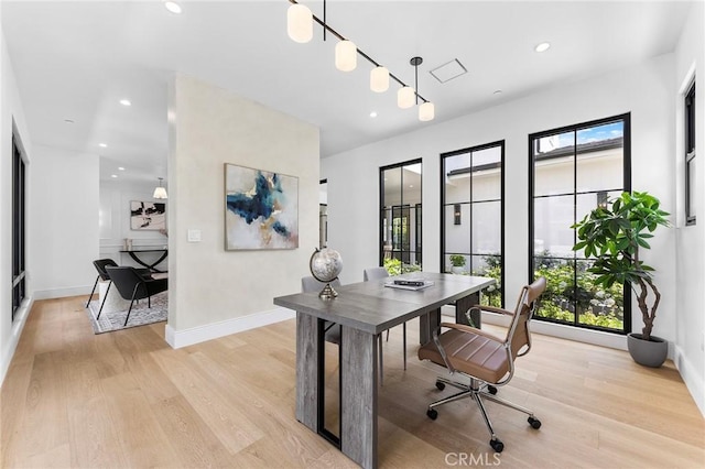 office area featuring light wood-type flooring and a healthy amount of sunlight