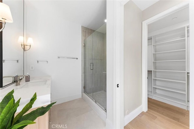 bathroom with vanity, hardwood / wood-style floors, and walk in shower