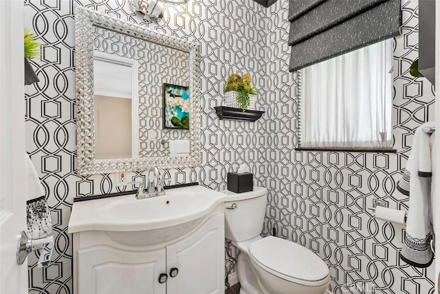 bathroom featuring toilet and vanity