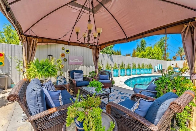 view of patio / terrace with an outdoor hangout area, a gazebo, and a fenced in pool