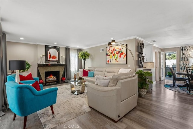 living room with ornamental molding and hardwood / wood-style flooring