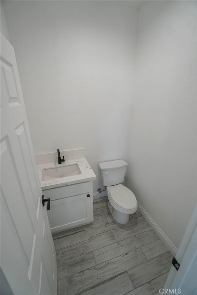 bathroom featuring toilet and vanity