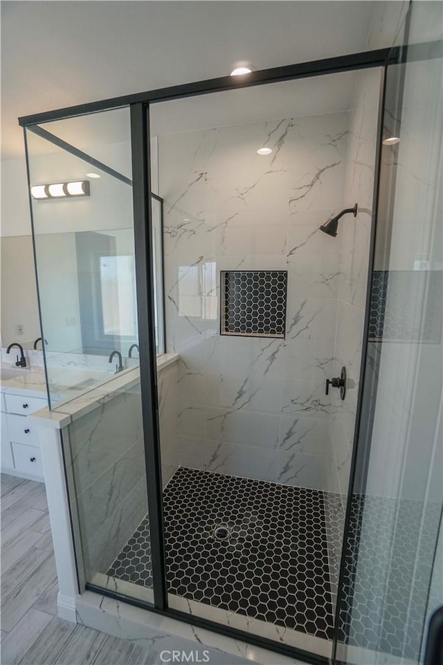 bathroom featuring an enclosed shower and vanity