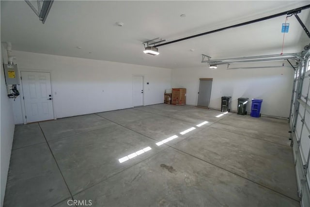 garage featuring water heater and a garage door opener