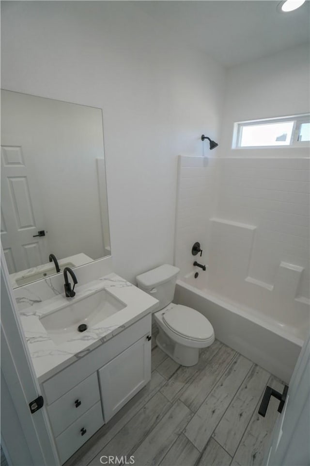 full bathroom with toilet, vanity, and bathtub / shower combination