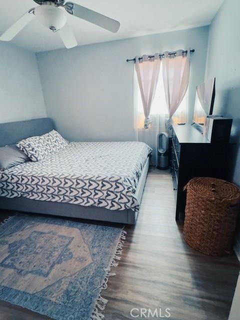 bedroom with ceiling fan and dark hardwood / wood-style flooring