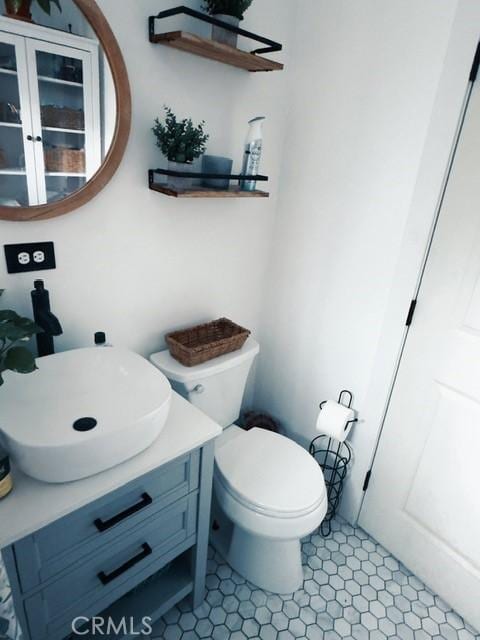 bathroom featuring toilet and vanity