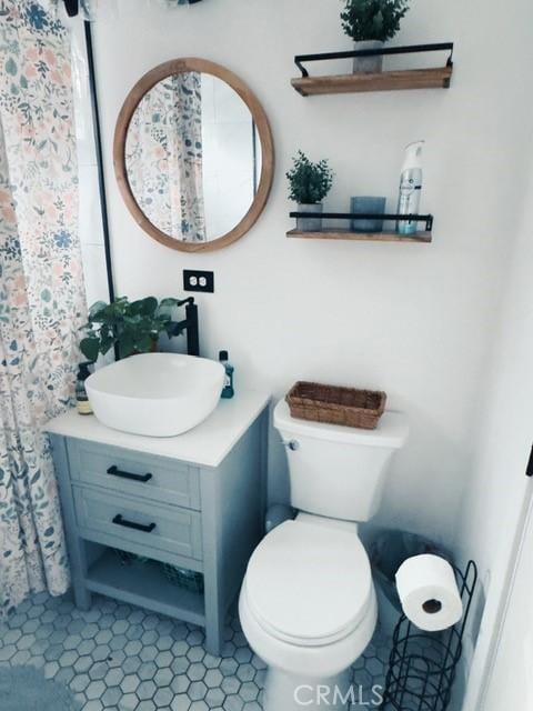 bathroom featuring toilet and vanity