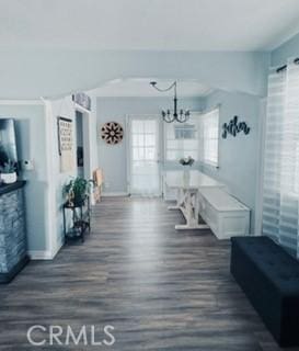 mudroom with dark wood-type flooring and a notable chandelier