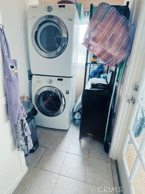 washroom featuring stacked washing maching and dryer