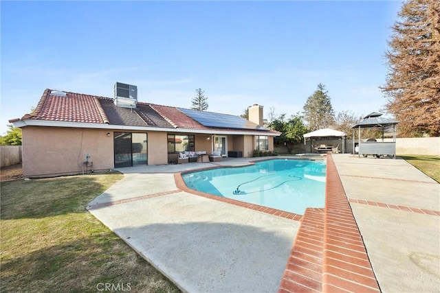 view of pool featuring central AC, a gazebo, a patio area, and a yard