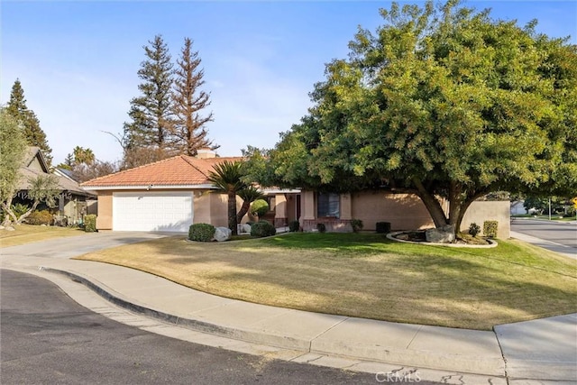 view of front of home with a front lawn and a garage