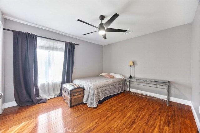 bedroom with ceiling fan and wood-type flooring