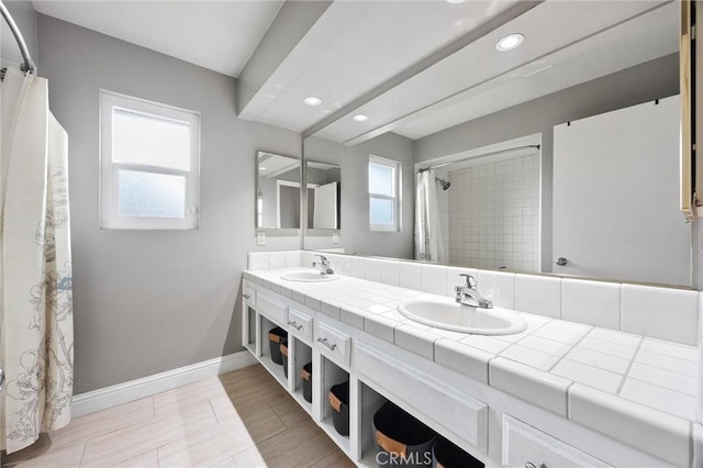 bathroom with vanity, a shower with curtain, and a wealth of natural light