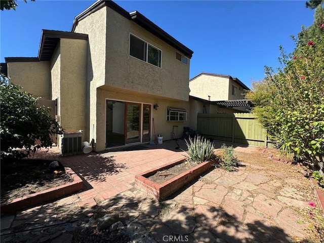 back of house with a patio area and central AC